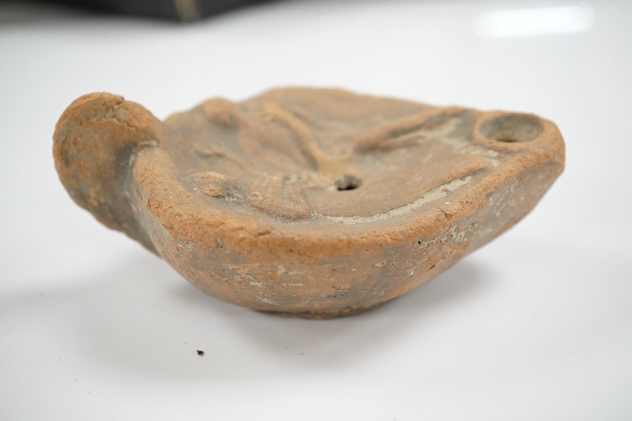 An Ancient Greek 'Athens' terracotta oil lamp, 10cm. Condition - fair